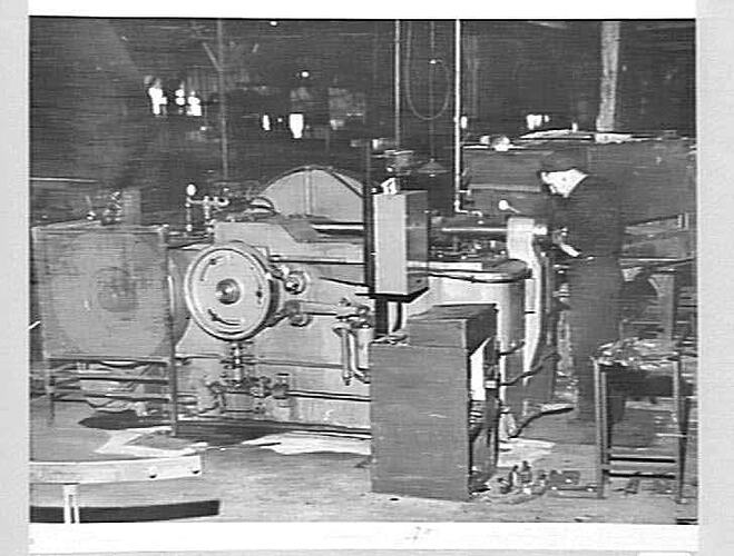 JULY 1950: ALBERT HUMPHRIES IS THE OPERATOR OF THIS NEW UP-SETTING AND FORGING MACHINE THAT WAS RECENTLY INSTALLED IN THE BLACKSMITHS' DEPARTMENT. THIS LARGE MACHINE, AND ITS' BIGGER BROTHER THAT IS YET TO BE INSTALLED, ARE THE MOST MODERN MACHINES OF THE