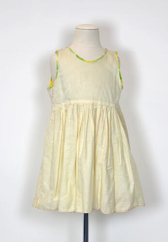Yellow child's petticoat dress, sleeveless, front view.