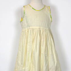 Yellow child's petticoat dress, sleeveless, front view.