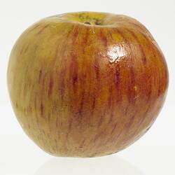 Wax model of an apple with a short stem, painted yellow and red.