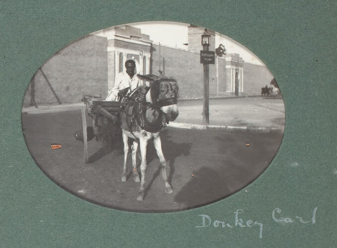Man on donkey cart.