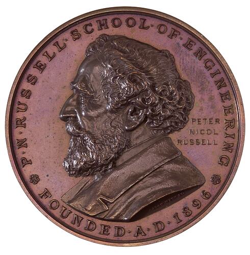 Round medal with bearded male profile facing left,