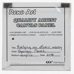 Label on back of white canvas with printed and handwritten text.