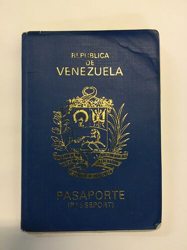 Navy passport cover with gold printing.