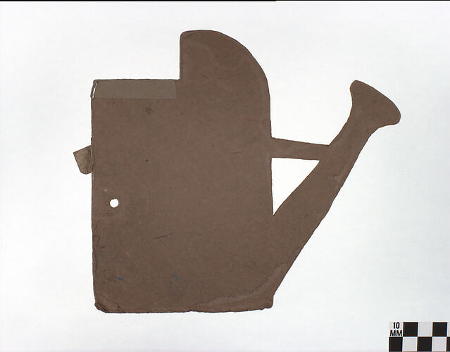 Thick, brown cardboard cut into watering can shape.