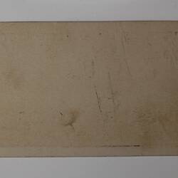 Back of off-white rectangular label.