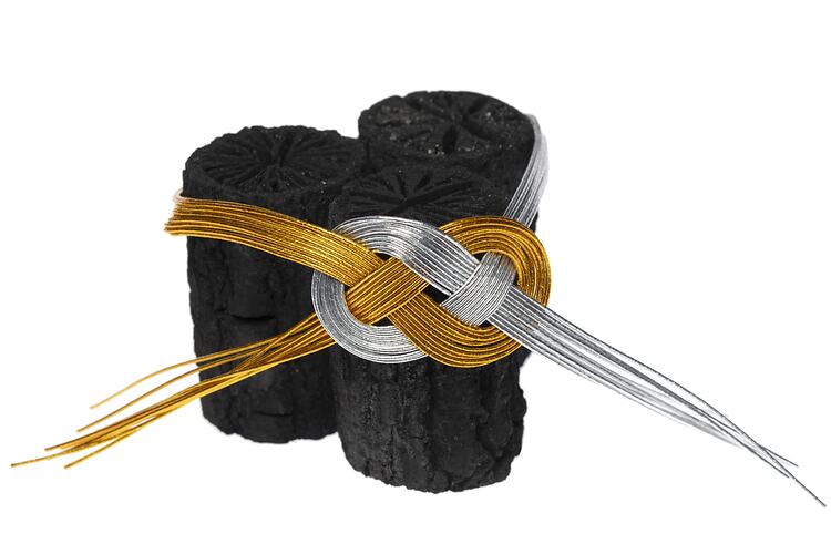 Set of three charcoal sticks, bound together with gold and silver coated wire.