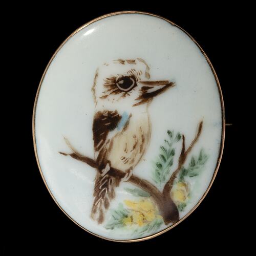 White porcelain brooch with painted kookaburra.