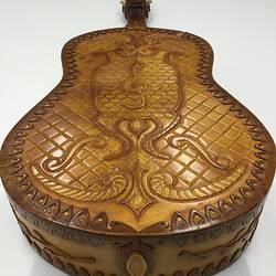 Back view of decorative brown wooden mandolin.