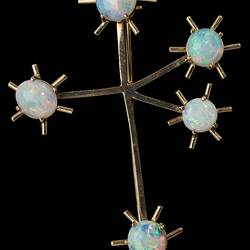 White opal and gold brooch the shape of the southern cross.