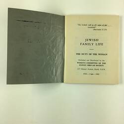Open booklet, left side is inside of front blue grey cover. Right side is white page with black printed text.