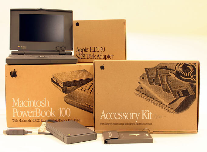 Apple Macintosh laptop with accessories.