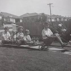 Digital Photograph - Boy on Billy Cart Towing Four Children on Trailer, Mount Waverley, 1961