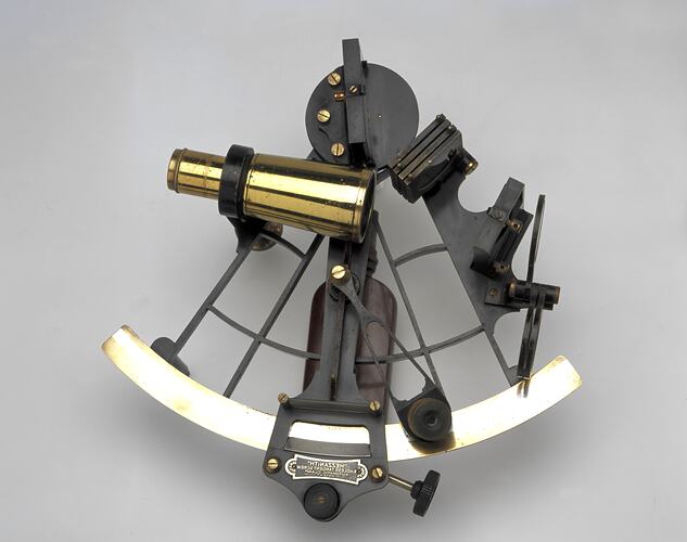 Brass and black metal sextant.