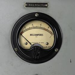 Close up of round computer dial used to measure milliamperes. White face, black lines and text.