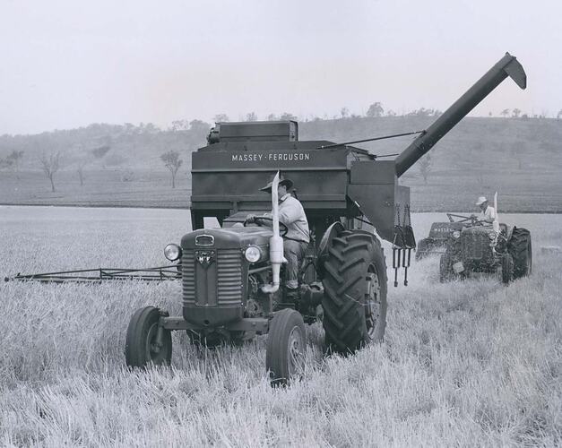 Tractor and harvester in front of baler in field.