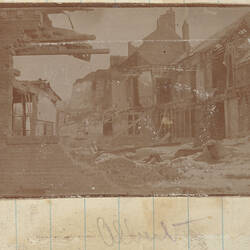 Damaged buildings and piles of debris.