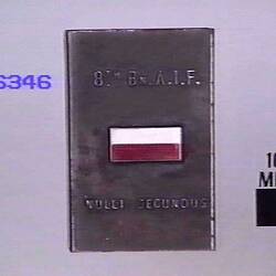 Steel matchbox holder with enamelled colour patch of 8th battalion (red & white rectangle) and  text.