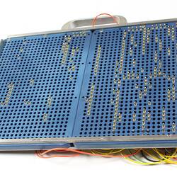 Blue board with holes and metal pegs.