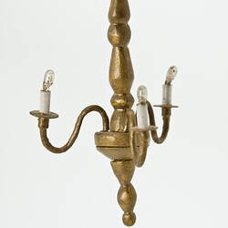 Three arm chandelier painted gold.