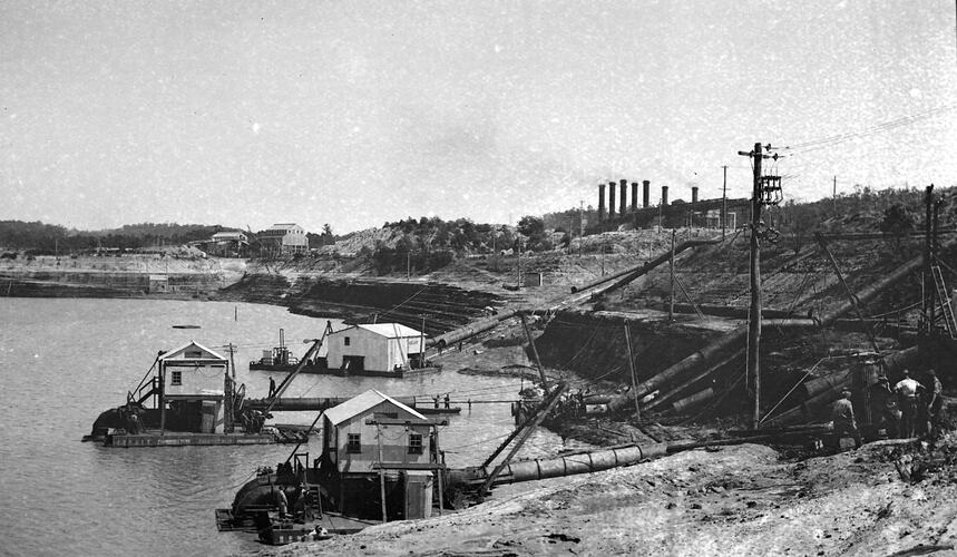 Pumping water from flooded open cut mine with power station in background.