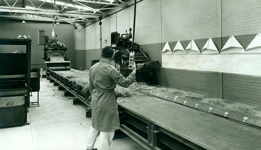 Man operating conveyor belt test machine.