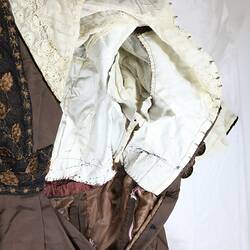 Brown silk dress, metal hooks, interior lining, embroidery.