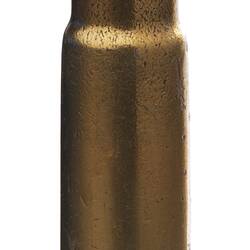 Copper bullet-shaped rifle cartridge with fine tip.