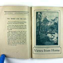 Open book with printed text on right page and photo of man in a canoe in bushland  on left page.