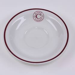Ceramic saucer with Coles Stores logo.