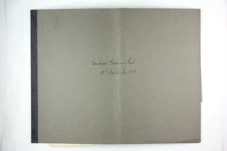 Book cover with handwritten title and tape binding.