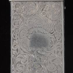 Silver cigar case with detailed engraved pattern  Text in centre. Hinged lid.