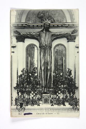 Front of postcard with Christ at church altar.