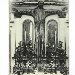Front of postcard with Christ at church altar.