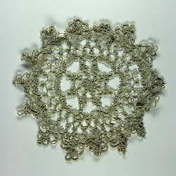 One side of stained cream doily.