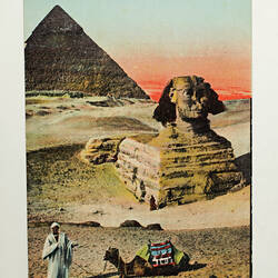 Coloured postcard with sphinx, pyramid, camel and man.