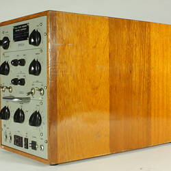 Control panel with knobs and dials. Housed in wooden box.