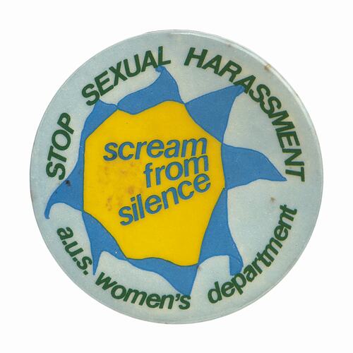 Round white badge, green text, central yellow and blue irregular jagged flower.