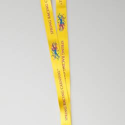 White card pass in plastic with yellow neck lanyard.