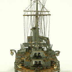 Naval ship with two masts, rear view.