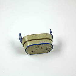 Underside, cream toy metal tub.