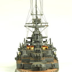 Naval ship with two masts, rear view.