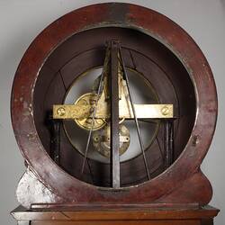 Wooden clock detail. Top back section showing mechanism.