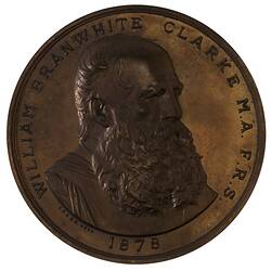 Medal with bust of man with beard, text around.