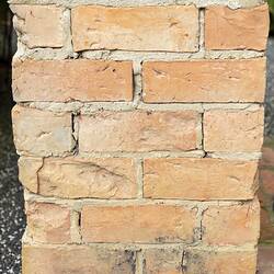 Red brick chimney detail. Side view bottom section.