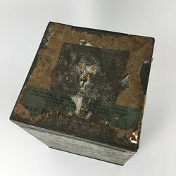 Top of tin box. Scuffed.