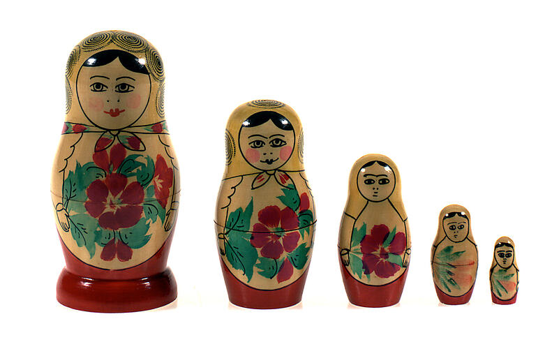 Painted Russian dolls in a line from largest to smallest.