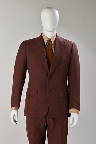 Brown jacket and pants suit. Jacket detail. Light brown shirt and brown tie.