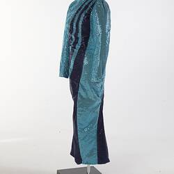 Aqua full-length sequin dress with navy swirls. Long sleeves, high neckline. Left rear angle.