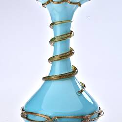 Pale blue opaque glass vase with gilded ribbon spiralling from base up to top. Flared neck with frill at top.